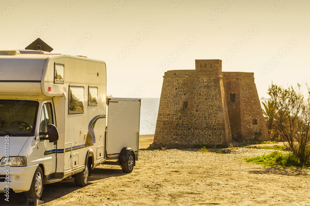 Obraz premium Caravan at castle tower on spanish coast