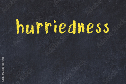 College chalk desk with the word hurriedness written on in