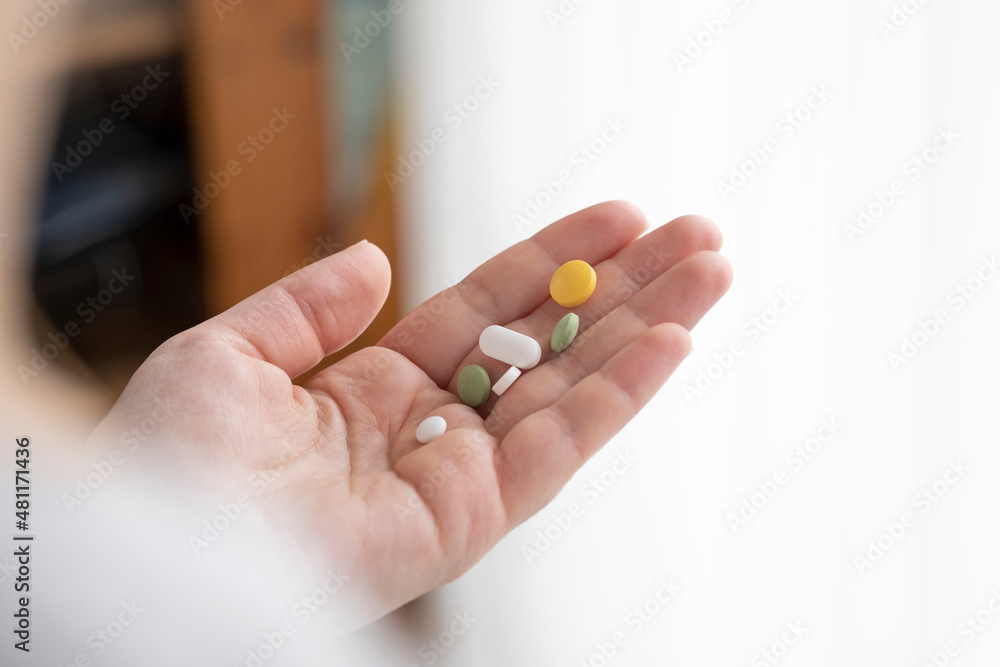 hands holding a pill hands holding a pill
