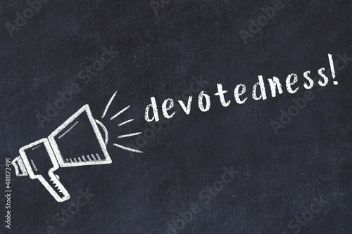 Chalk loudspeaker and inscription devotedness on black chalkboard