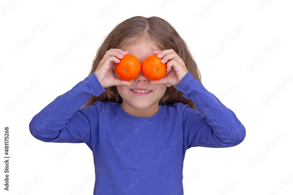 Smiling and happy child kid holding tandarines on eyes, isolated on white background looking at camera waist up caucasian little girl of 5 years in blue Smiling and happy child kid holding tandarines on eyes, isolated on white background looking at camera waist up caucasian little girl of 5 years in blue