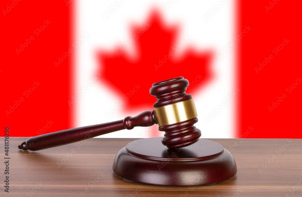 Wooden gavel in background of Canadian flag