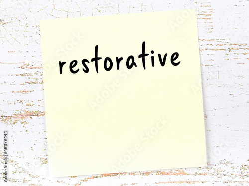 Canvas Yellow sticky note on wooden wall with handwritten word restorative