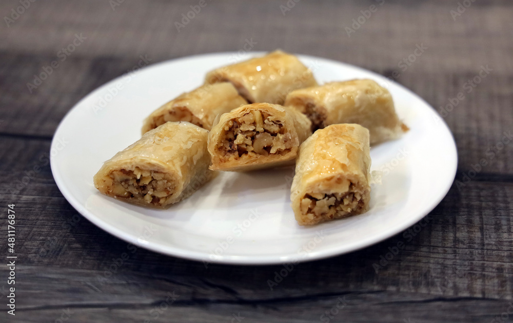 A white plate full of freshly baked Lebanese baklawa. A white plate full of freshly baked Lebanese baklawa.