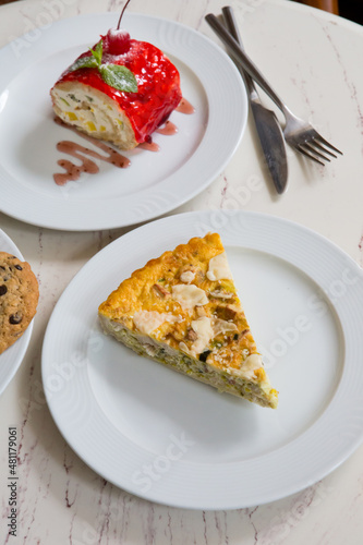 Piece of french quiche pie with cheese and spinach