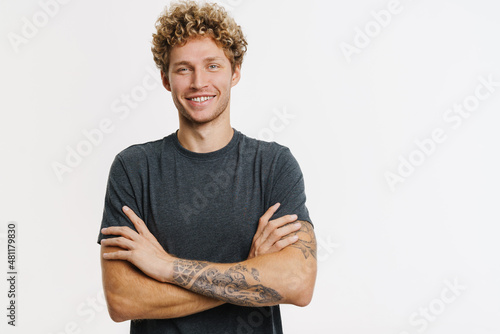 Tableau sur toile Young blonde man with curly hair smiling and looking at camera