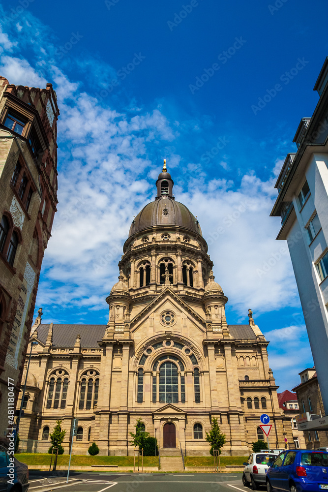Lovely view of the famous Protestant church Christuskirche (Christ Church) from the street Ernst-Ludwig-Straße in Mainz, Rhineland-Palatinate, Germany on a sunny day with a blue sky.