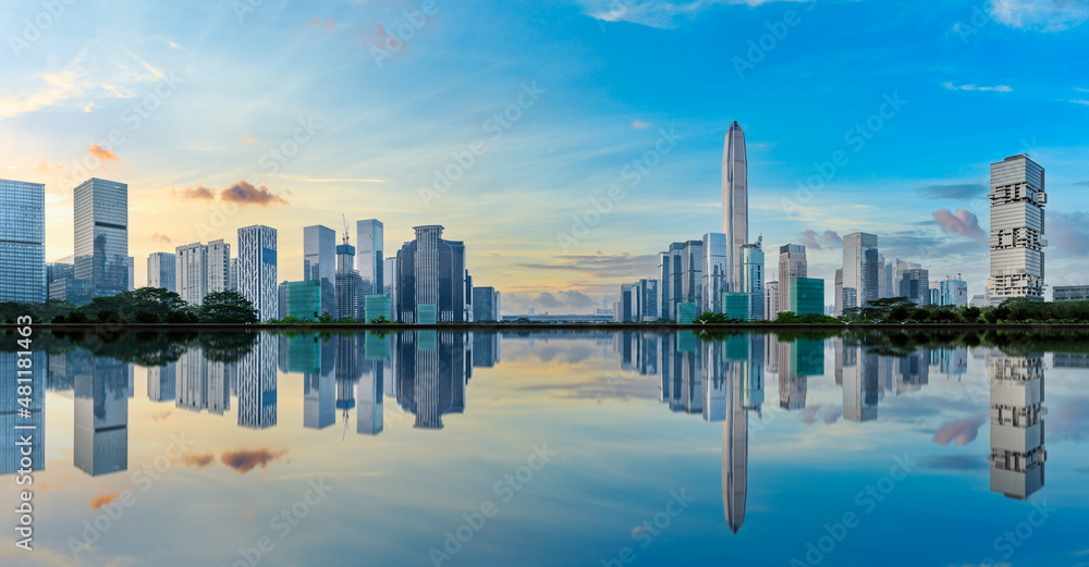 Panoramic skyline and modern commercial buildings with water reflection in Shenzhen, China.