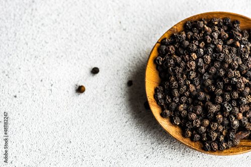 Overhead view of a bowl of black peppercorns