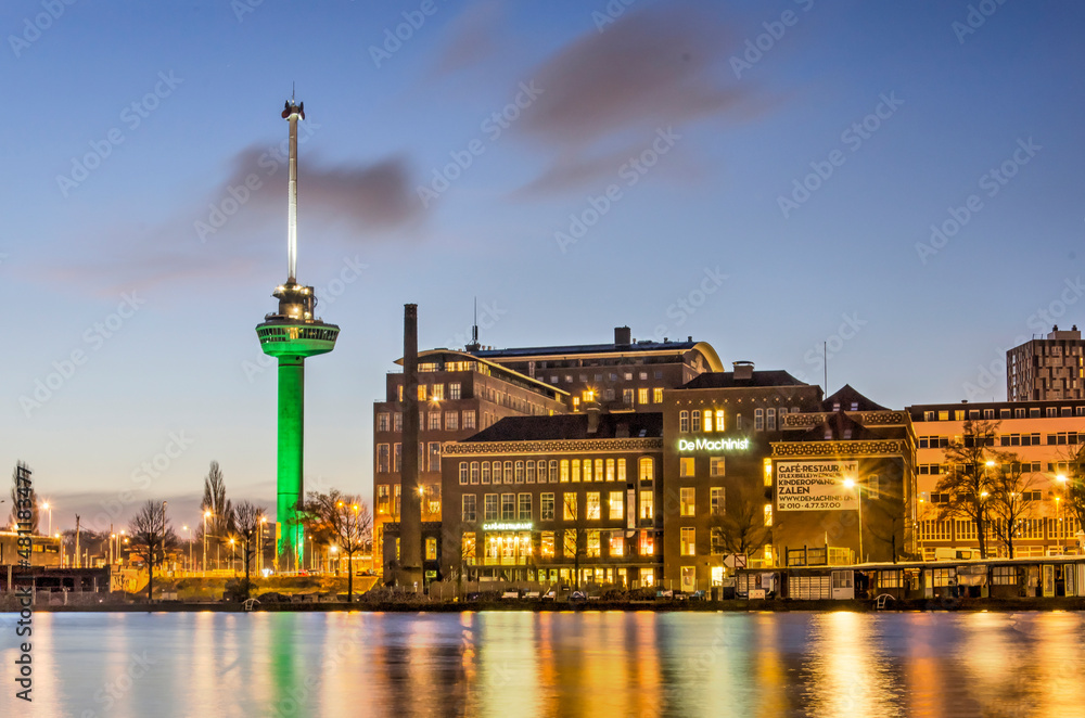 Rotterdam, The Netherlands, January 17, 2022: view across Coolhaven harbour towards the historic  Machinist building and Euromast observation tower during the blue hour on a winter morning