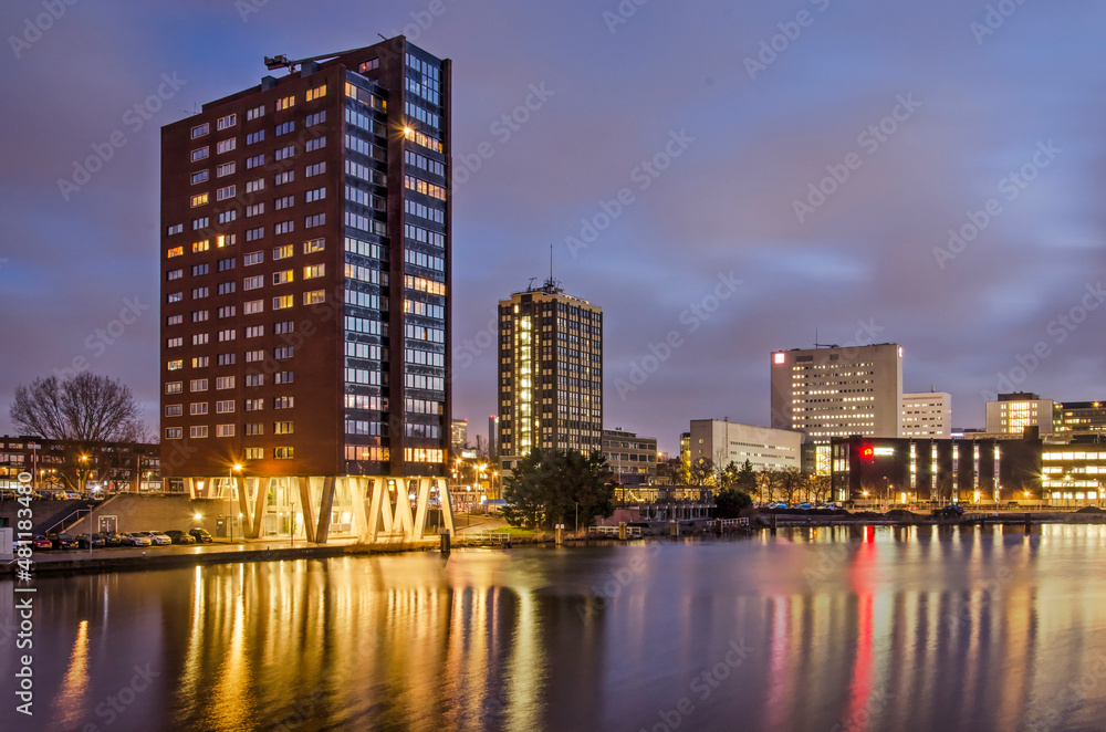 Rotterdam, The Netherlands, January 17, 2022: view of Coolhaven harbour with several residential and educational buildings at its banks, during the blue hour on a winter morning