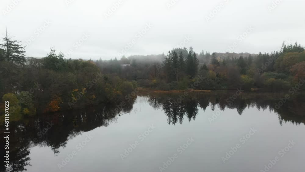 Cinematic drone shot of a small forest then revealing a small building on the River Eske in Donegal, Ireland Cinematic drone shot of a small forest then revealing a small building on the River Eske in Donegal, Ireland