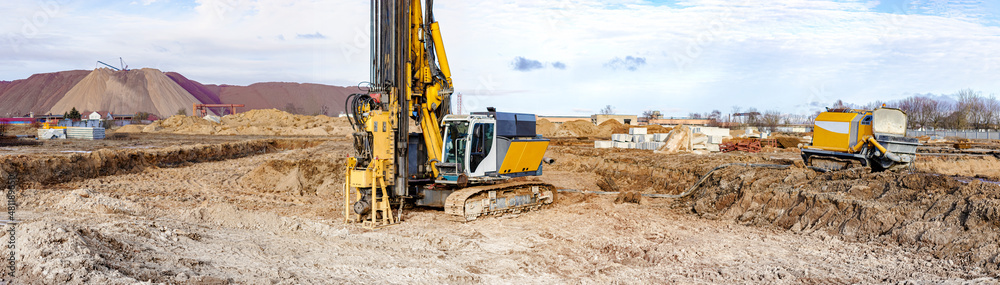 A powerful drilling rig for peeling at a construction site. Operation of the drilling rig in northern conditions. Pile foundations. Bored piles. Pagoramic view. Banner format. A powerful drilling rig for peeling at a construction site. Operation of the drilling rig in northern conditions. Pile foundations. Bored piles. Pagoramic view. Banner format.