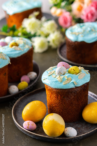 Festive table, Easter cake decorated with glaze, almond flakes and colorful eggs, Happy Easter
