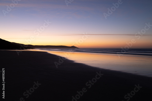Tregantle Beach in Whitsand Bay Cornwall at sunrise with reflections in the sand and sea © Jim Peters