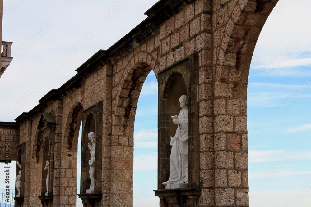Statues and arches on Montserrat Monastery exterior, Catalonia, Spain.