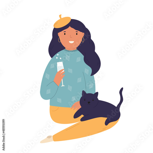 Happy girl sitting with a glass of cocktail and a cat on her knees