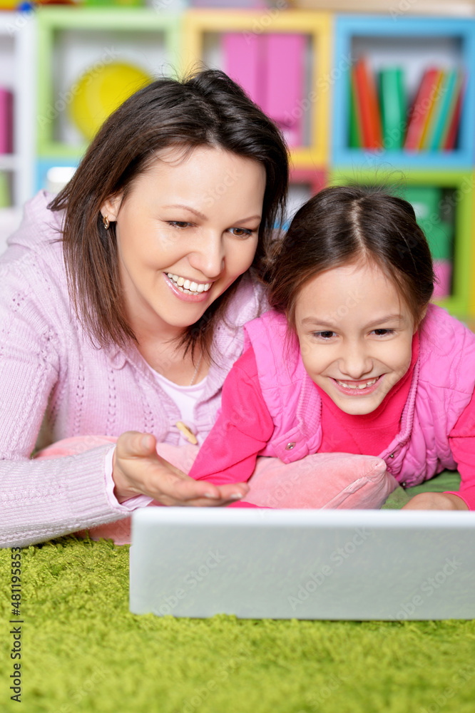 Portrait of happy mother and daughter using laptop together Portrait of happy mother and daughter using laptop together