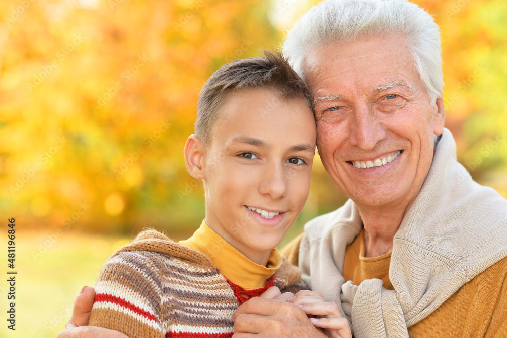 Portrait of happy grandfather and grandson in park Portrait of happy grandfather and grandson in park