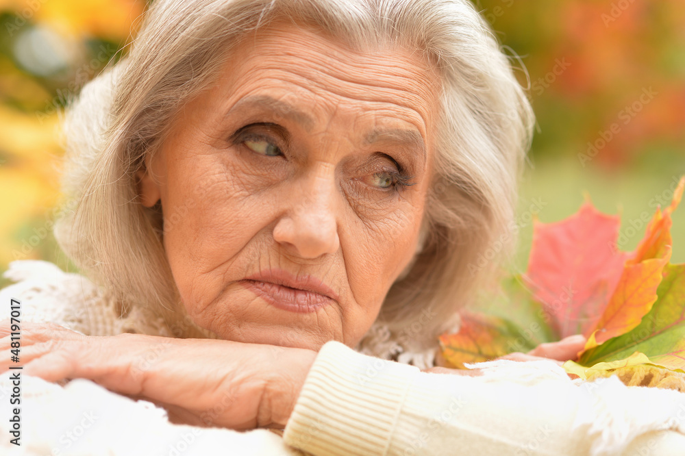 Portrait of sad senior woman in autumn park Portrait of sad senior woman in autumn park
