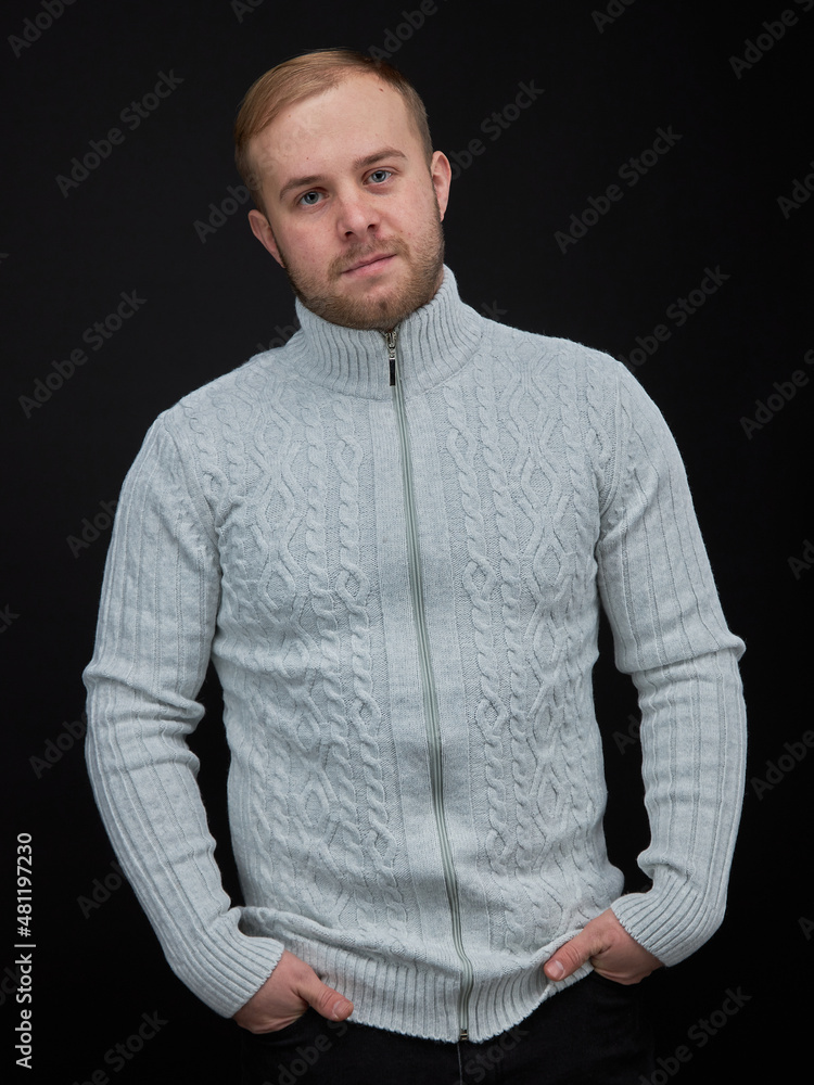 vertical portrait blond man on a dark background, in a jacket vertical portrait blond man on a dark background, in a jacket