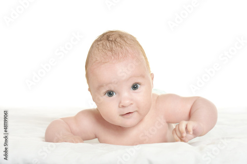 Portrait of cute baby girl on white blanket