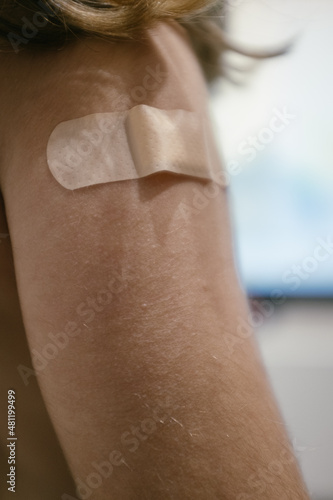 Band aid on a child shoulder after getting vaccinated