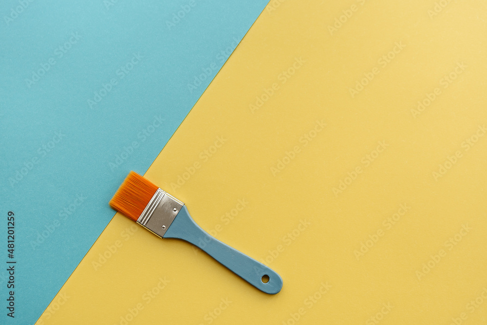 Brush on a bed paper background of yellow and blue Brush on a bed paper background of yellow and blue