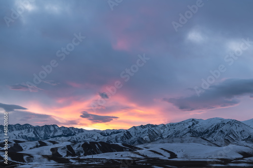 colorful sunrise over snowy mountains, mountain panorama
