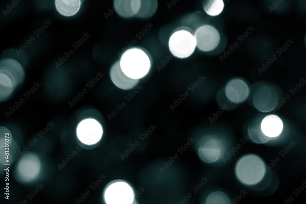 Tidewater Green colors. Defocused bokeh christmas white lights on dark green background. Blurred abstract green glitter texture. Green bokeh glitter wallpaper for Christmas, New year. Tidewater Green colors. Defocused bokeh christmas white lights on dark green background. Blurred abstract green glitter texture. Green bokeh glitter wallpaper for Christmas, New year.