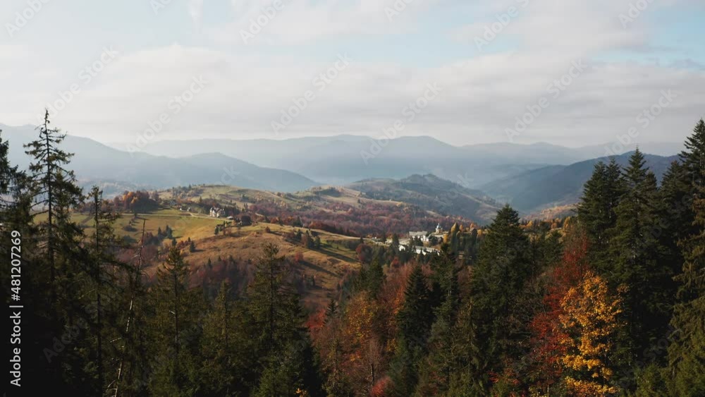Mountain valley with houses and forests at sunrise Mountain valley with houses and forests at sunrise