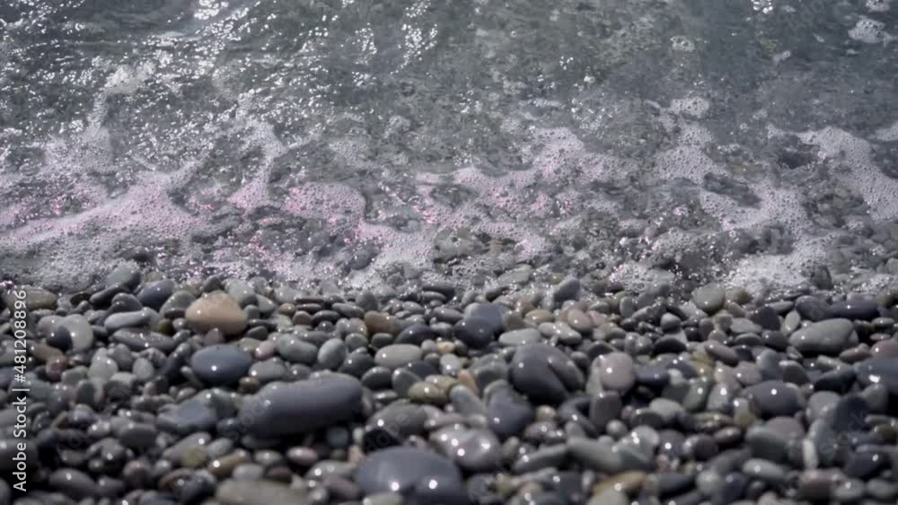 Foamy sea waves on an empty pebble beach Foamy sea waves on an empty pebble beach