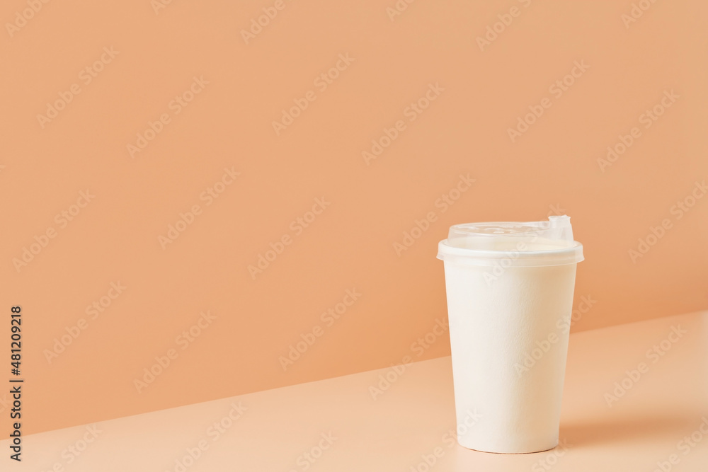 Paper unbranded white glass for drinks on a colored background, close-up with copy space for text.Cardboard eco-friendly cup Paper unbranded white glass for drinks on a colored background, close-up with copy space for text.Cardboard eco-friendly cup