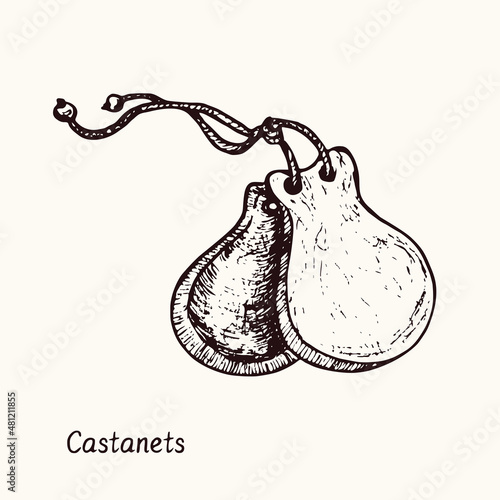Castanets. Ink black and white doodle drawing in woodcut style with inscription. photo