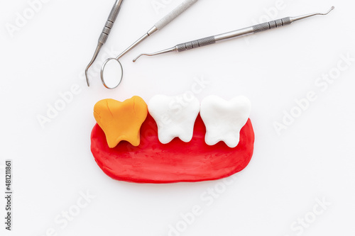 Teeth models with dentist tools. Oral health and care concept