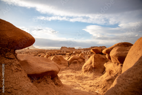 Hoodoo formations, created by sandstone erosion, in a desert landscape in Goblin Valley State Park on a rainy spring day.
