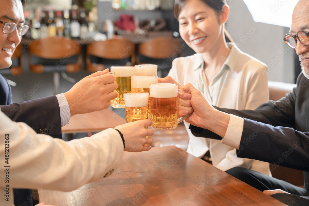 ビールで乾杯する会社帰りの打ち上げ飲み会手元