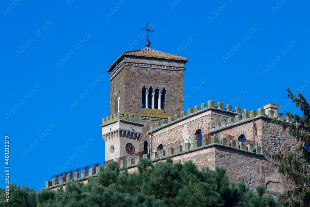 Remote view of Bell tower and clock tower of The Santa Maria Assunta Cathedral(Sutri)is one of the few remains of the medieval church in Lazio,Italy.Located in the heart of the ancient city