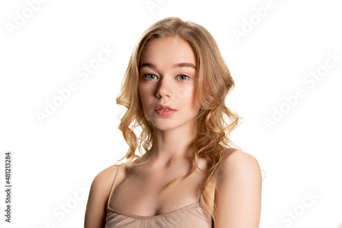 Half-length portrait of young beautiful girl with day makeup isolated over white studio background. Natural beauty concept.