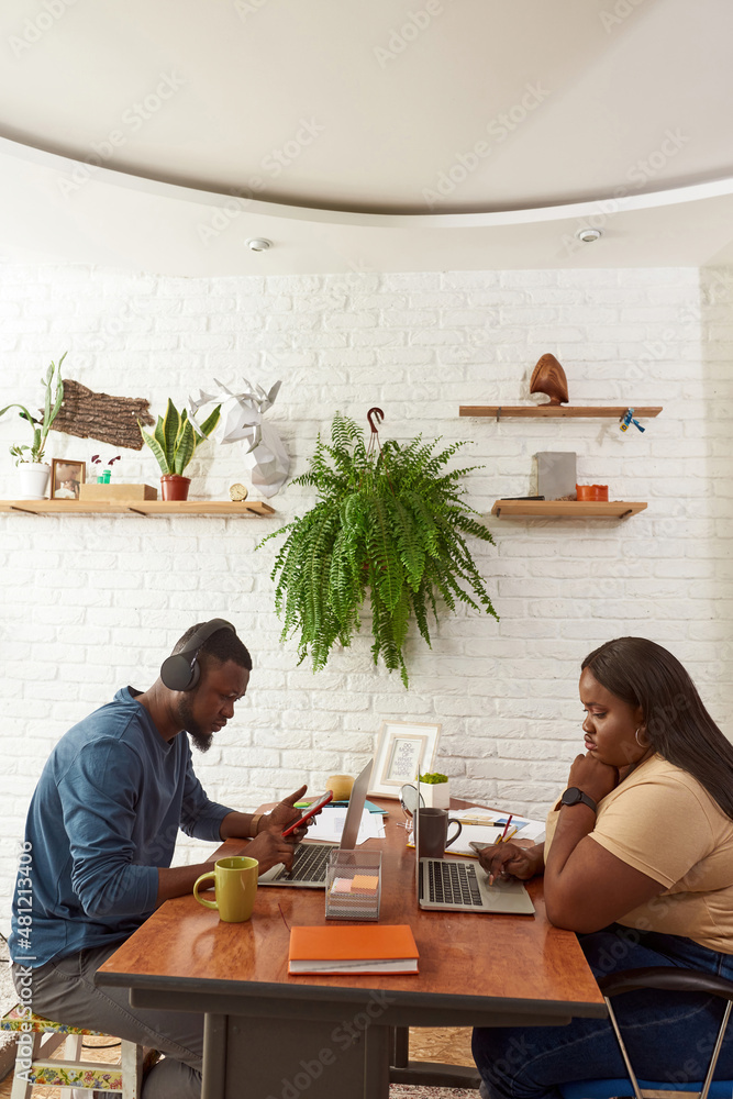 Black man and girl working with digital devices Black man and girl working with digital devices