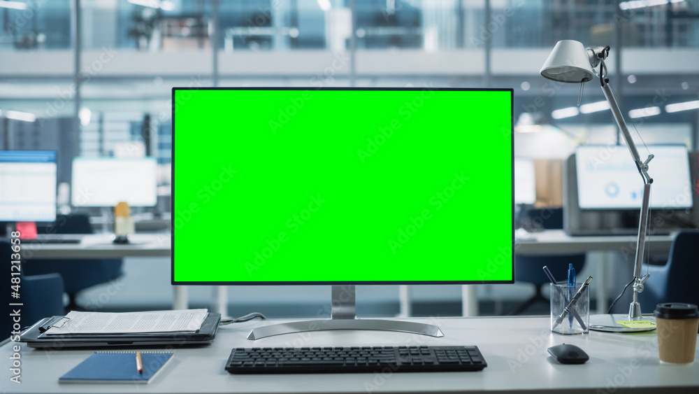 Desktop Computer Monitor with Mock Up Green Screen Chroma Key Display  Standing on the Desk in the Modern Business Office. In the Background Glass  Wall with Big City Office. Stock-Foto | Adobe