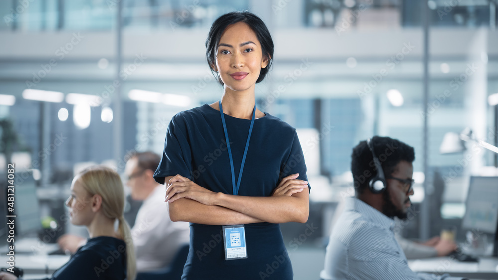 © Gorodenkoff - Successful Businesswoman in Stylish Dress Crossing Arms, Standing in Modern Office with Diverse Working on Financial, Business and Marketing Projects. Portrait of Beautiful Asian Manager. © Gorodenkoff - Successful Businesswoman in Stylish Dress Crossing Arms, Standing in Modern Office with Diverse Working on Financial, Business and Marketing Projects. Portrait of Beautiful Asian Manager.