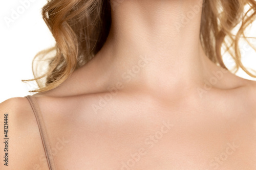Collarbones. Portrait of young female fashion model isolated on white studio background. Beautiful caucasian woman with healthy and well-kept skin.