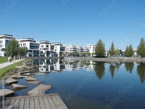 Modern houses, promenade and circular path at the Phoenix See in the Dortmund suburb of Hoerde, North Rhine-Westphalia, Germany