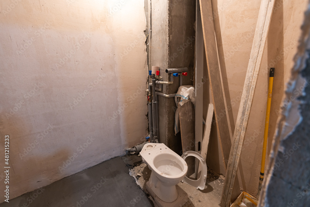 Obraz premium Toilet bowl in the bathroom. Repair. Sanitary ceramics. Plumbing. Water pipes. Plastic faucet. Floor standing toilet.