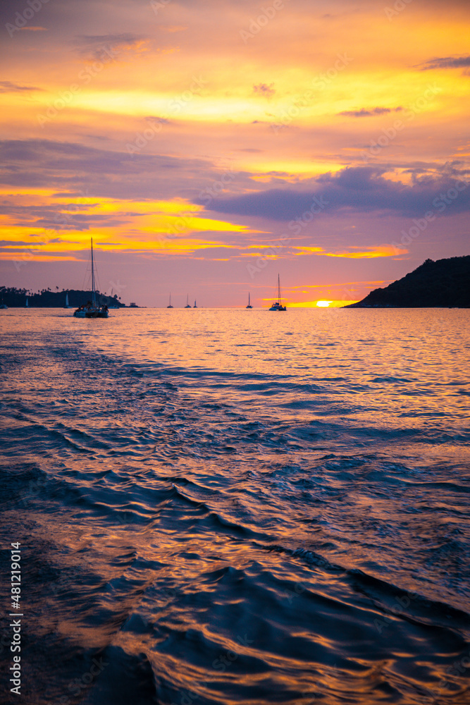 Sailing boat during sunset at Promthep Cape in Phuket peninsula, Thailand