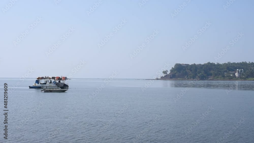 HD Time lapse scenery of the Mandovi river and marina in Goa with fishing vessel and a yacht in the foreground HD Time lapse scenery of the Mandovi river and marina in Goa with fishing vessel and a yacht in the foreground