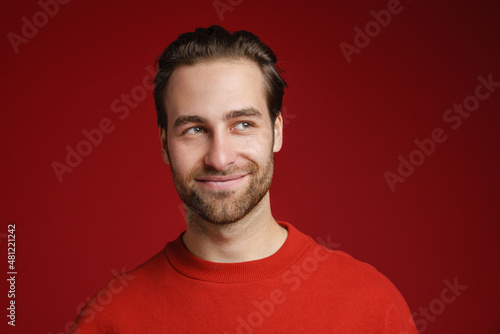 Young bristle man wearing long sleeve smiling and looking aside