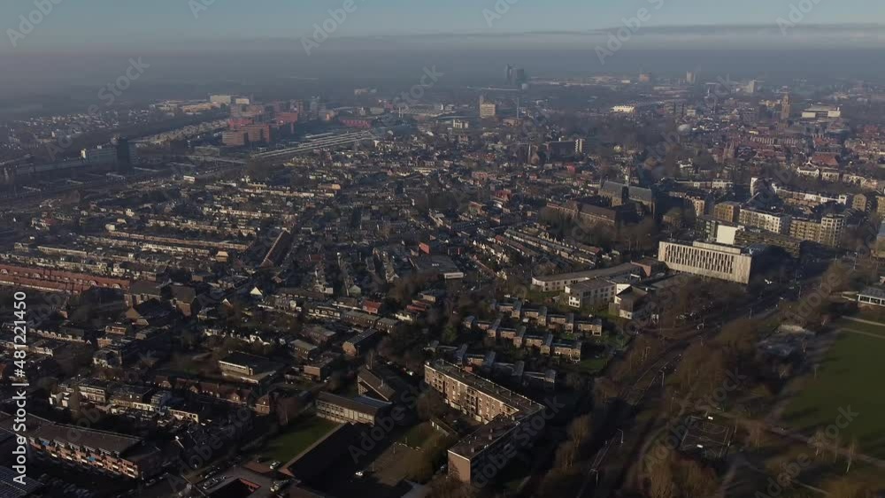 Aerial top view of a city in Holland, surrounded by houses, green trees and canal