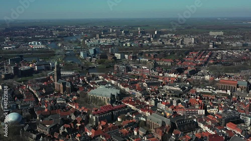 Aerial top view of a city in Holland, surrounded by houses, green trees and canal photo